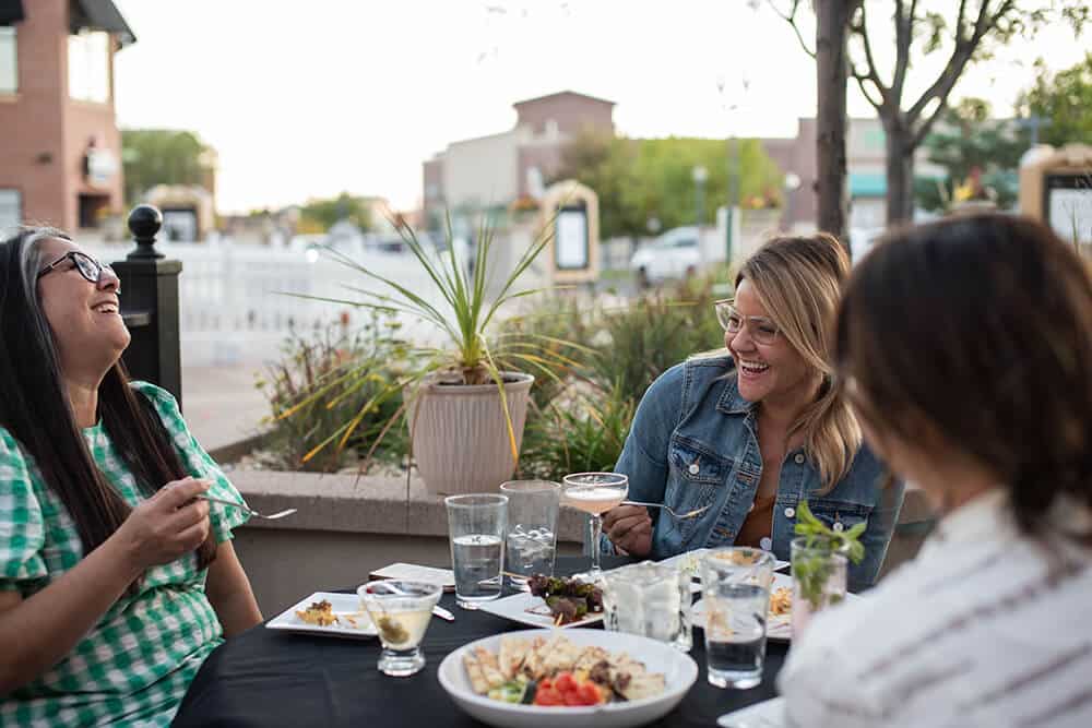 A group of friends enjoying happy hour in an restaurant patio