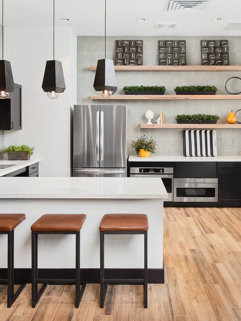 Stunning modern clubhouse kitchen with hanging black fixtures