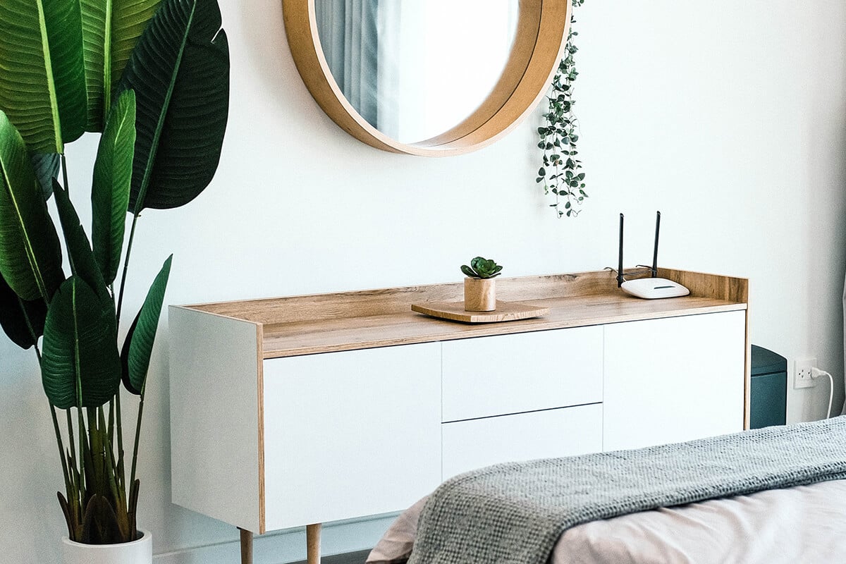 Cozy, airy bedroom with white walls and natural wood features
