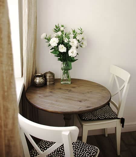 A small rustic, farmhouse dining nook with a bouquet of flowers