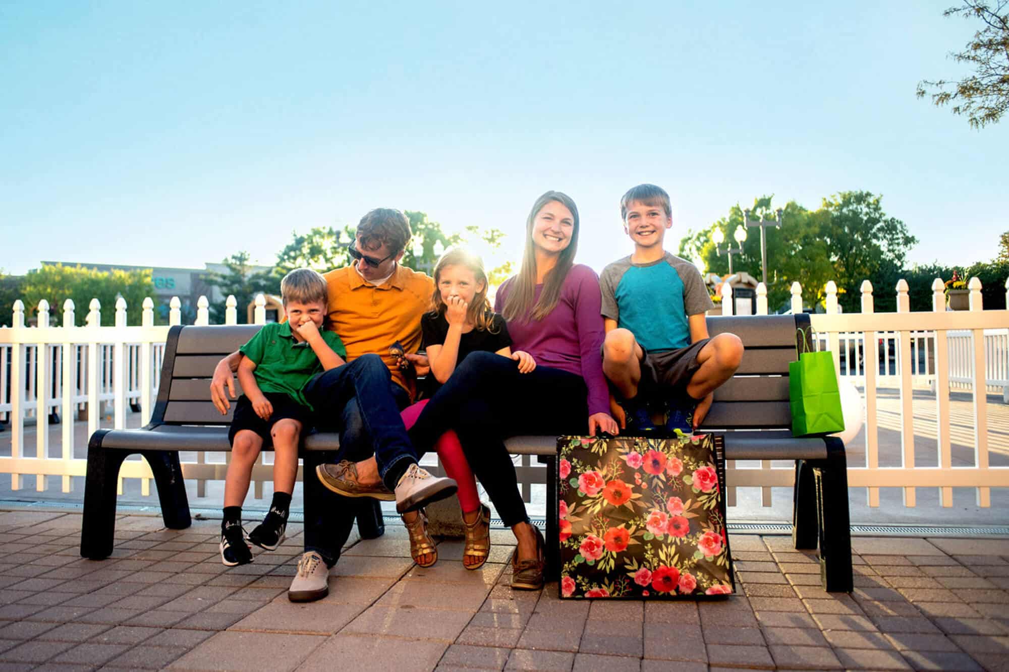 A family on a bench enjoying the First and Main Town Center